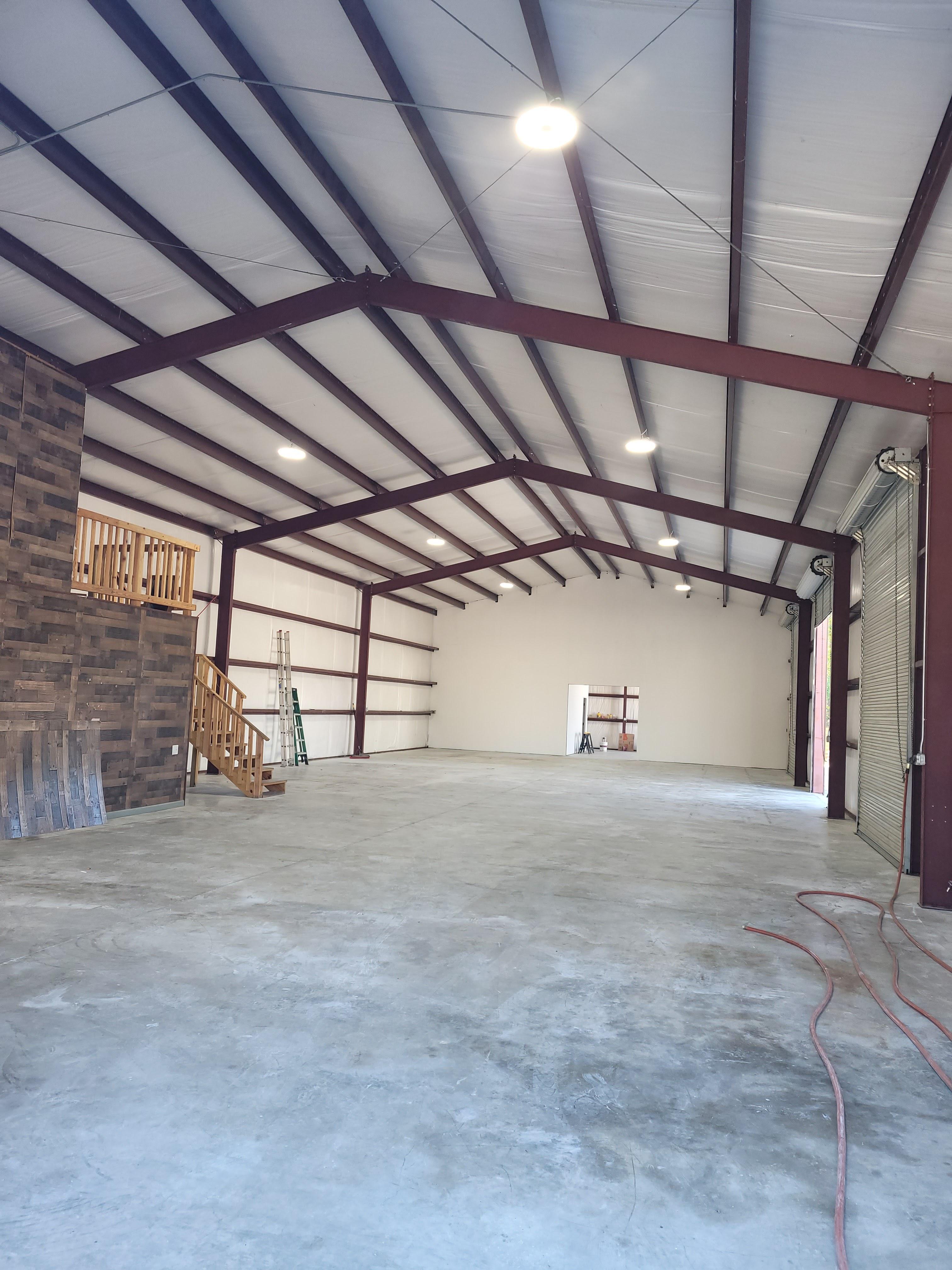 High bay lighting installed in a large metal workshop